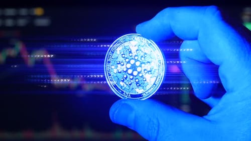 Concept of Cardano ADA digital cryptocurrency emitting electricity and computer code held in fingers