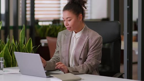 Woman Relaxes with Feet Up on Desk