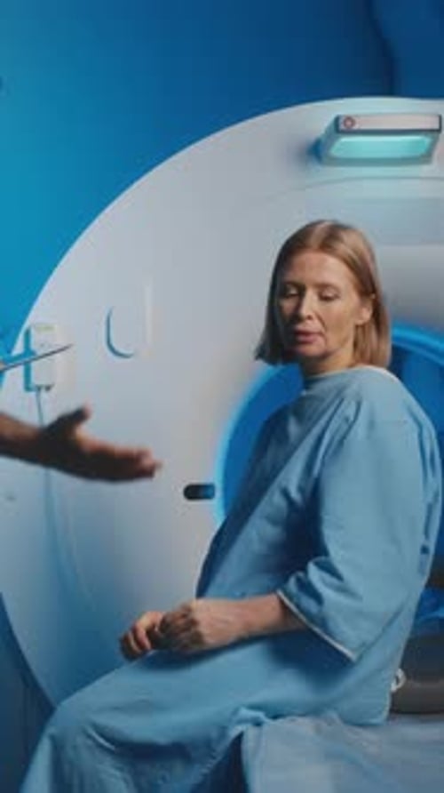 Woman in Gown Sits Near MRI Machine
