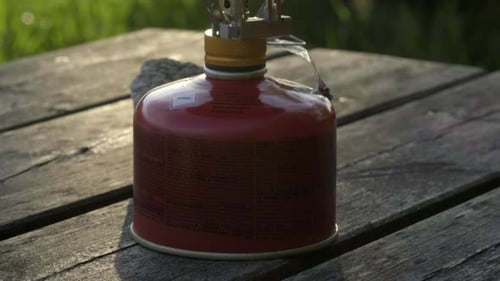 Camping Stove With Pot Sits On Picnic Table