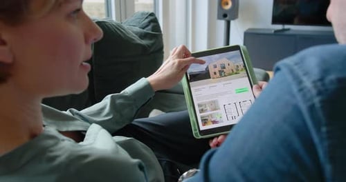Couple Looking at Real estate Property on Laptop