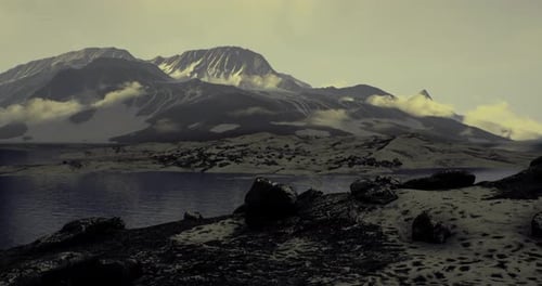 Majestic Mountain Landscape with Reflective Lake and Rugged Terrain