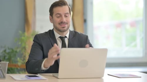 Businessman Uses Laptop for Online Video Conference