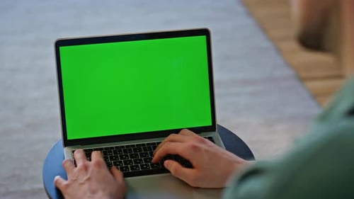 Typing on Laptop with Green Screen Mockup