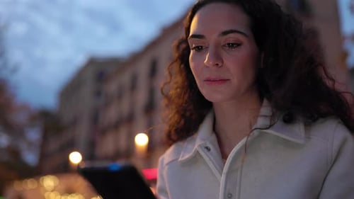 Beautiful Young Adult Woman Standing at City Street Using Mobile Phone