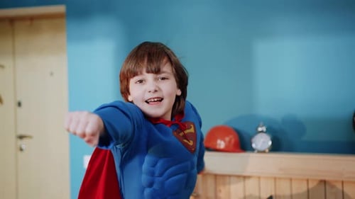 Smiling Boy in Superhero Costume in Playful Portrait