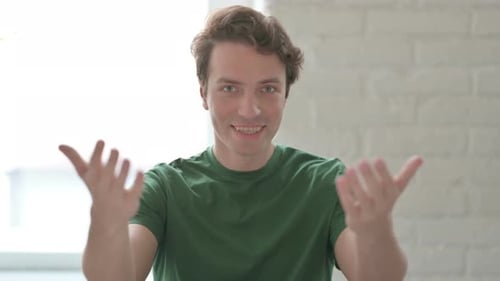 Inviting Young Adult Gesturing to the Camera