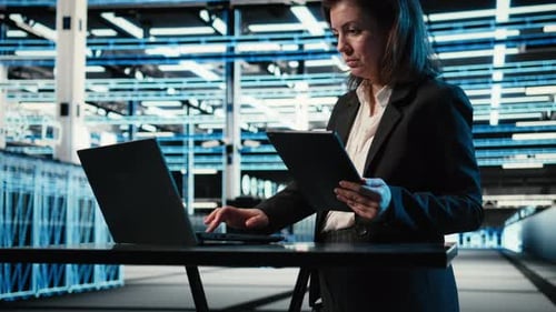 Data Center Specialist Crosschecking Settings Between Laptop and Tablet