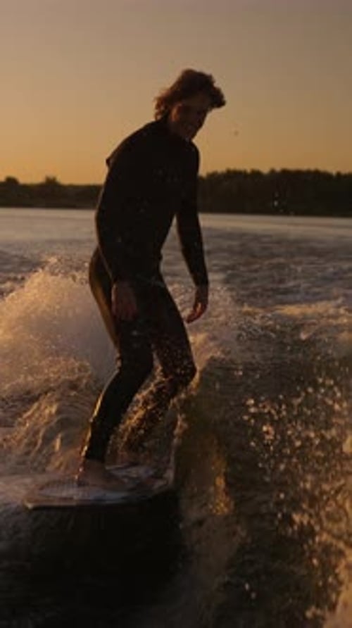 Adventurous Surfer Riding the Waves at Sunset Showcasing Skill and Elegance Against a Backdrop of