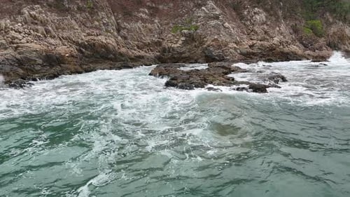Dynamic Ocean Waves Crashing on Black Stones with Strong Motion