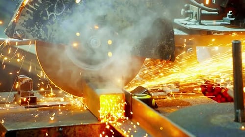 Worker Using an Angle Grinder Producing a Lot of Sparks