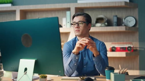 Young Adult Working at Computer in Modern Office