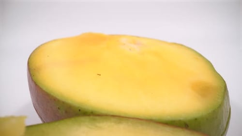 Cut mango macro on white background isolated 4K