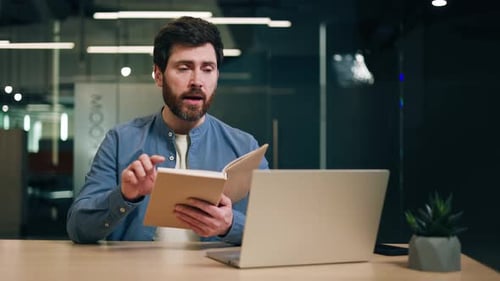 Corporate Man Speaking at Desk with Laptop