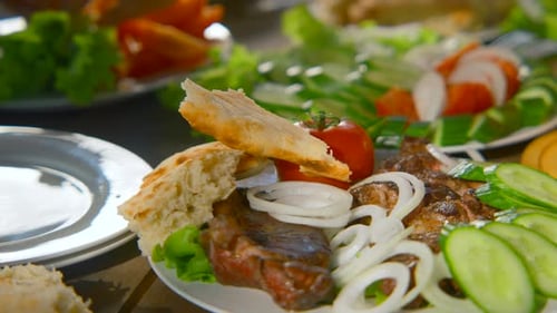 Close-up of table with meat and vegetables in nature