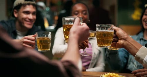 Hands, friends and cheers with beer in bar for reunion celebration, social event and night