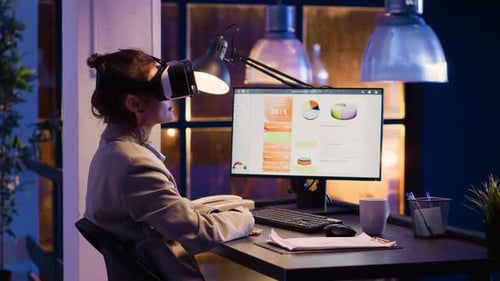 Businesswoman Uses VR Headset at Office at Night