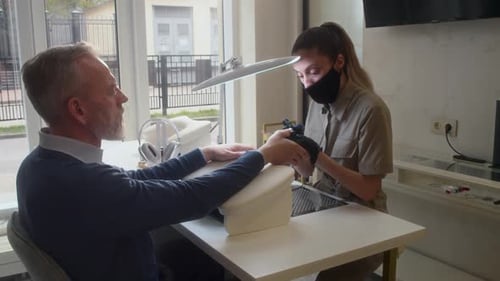Man Getting Manicure at Beauty Salon