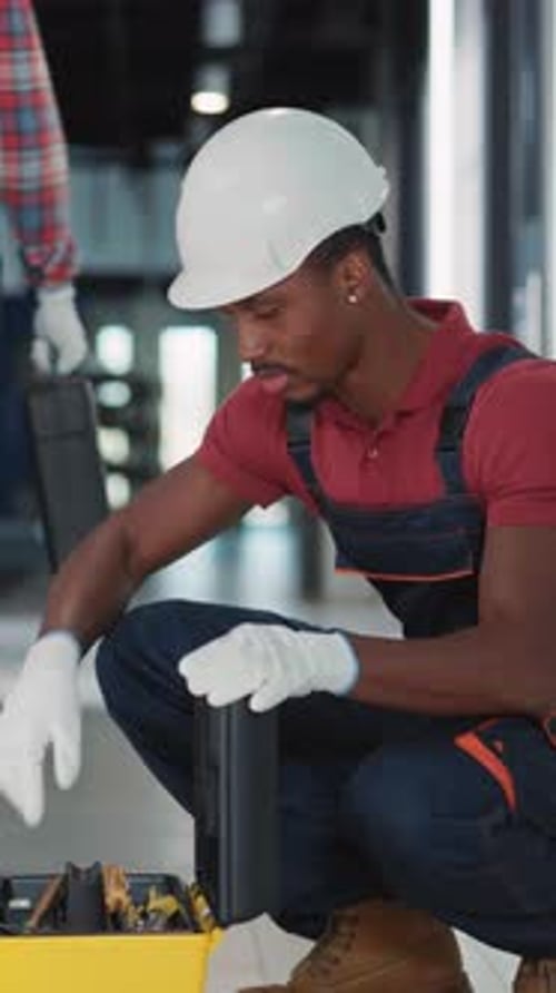A Professional Inspects Equipment in an Industrial Setting for Quality and Safety Wearing Gloves