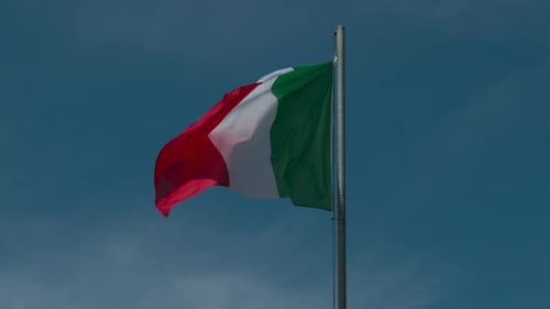 Italian Flag waving against a clear blue sky