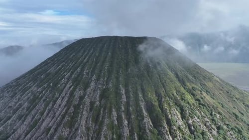 aerial view flying to mount Bromo active volcano above sea of clouds, Java, Indonesia