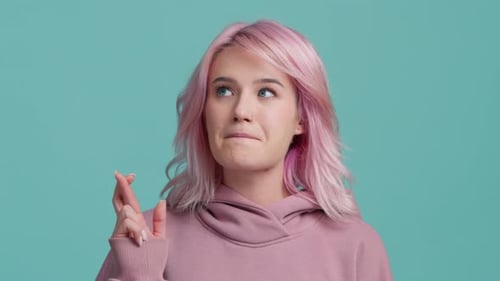 Young Woman with Pink Hair Crosses Fingers