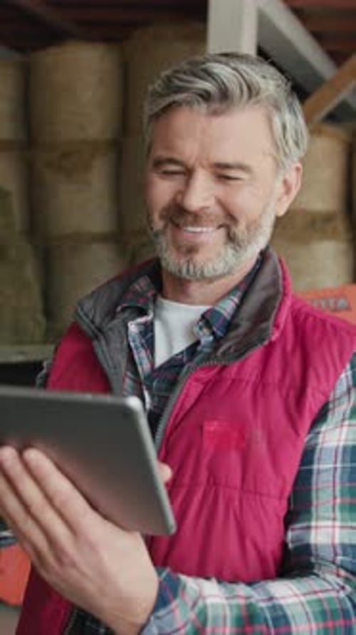Portrait Handsome Young Farmer in Hat Standing Look at Camera On Background Tractor In Farm Close Up