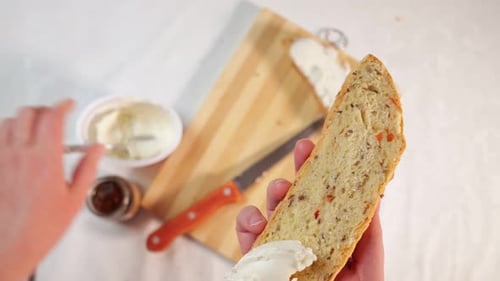 Spreading Cream Cheese on Bread Slice with Knife