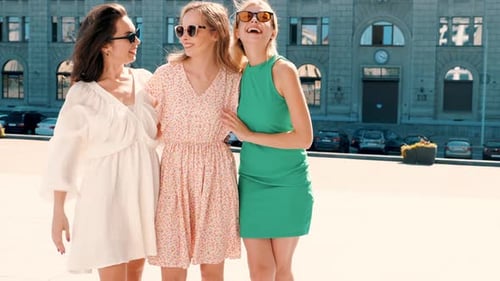 Happy Stylish Women Friends Standing Together in City