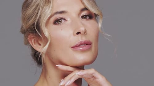 Studio Portrait of Young and Beautiful Blond Woman Over Grey Background Skin Care and Wellness