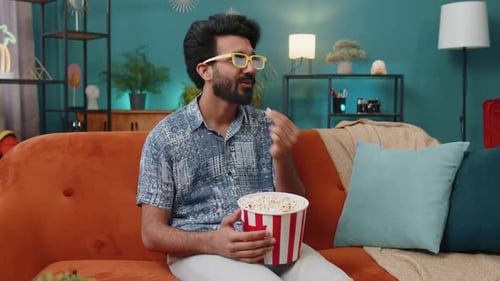Young Man Enjoys Movie with Popcorn at Home