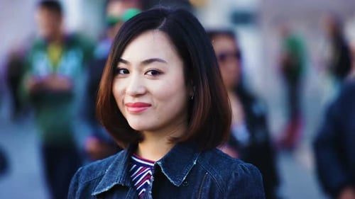 pretty Asian Woman in the city smiles happy - portrait