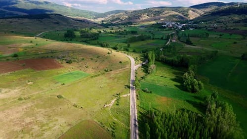Aerial view of a road leading to a small village