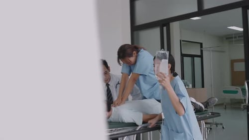 Emergency Team Moving Critically Ill Patient While Providing Care