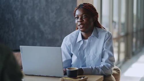 Afro American Colleagues in Formal Wear Leading Business Meeting Over Fresh Coffee at Cafe