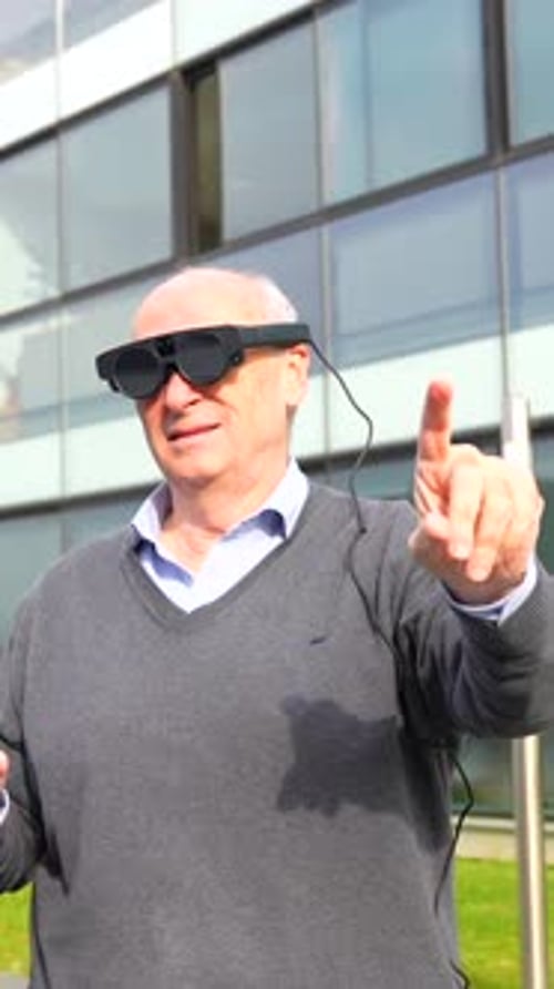 Senior Man Wearing Augmented Reality Glasses Outside