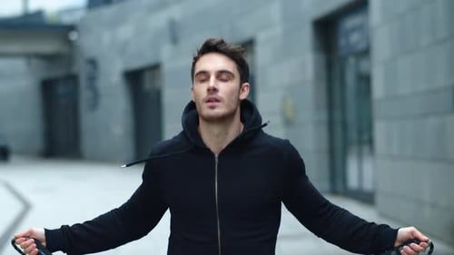 Athletic Man Skipping Rope Outdoors in Urban Setting
