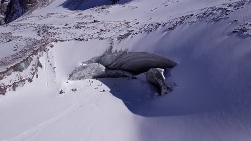 A Huge Glacier in the Mountains and Tourists