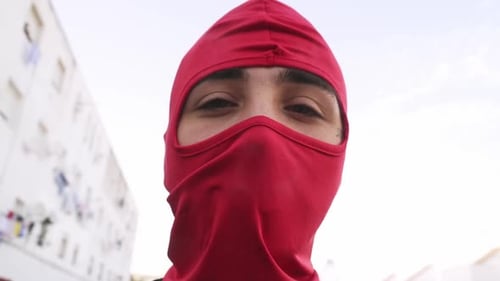 Close-Up of Person Wearing a Red Ski Mask