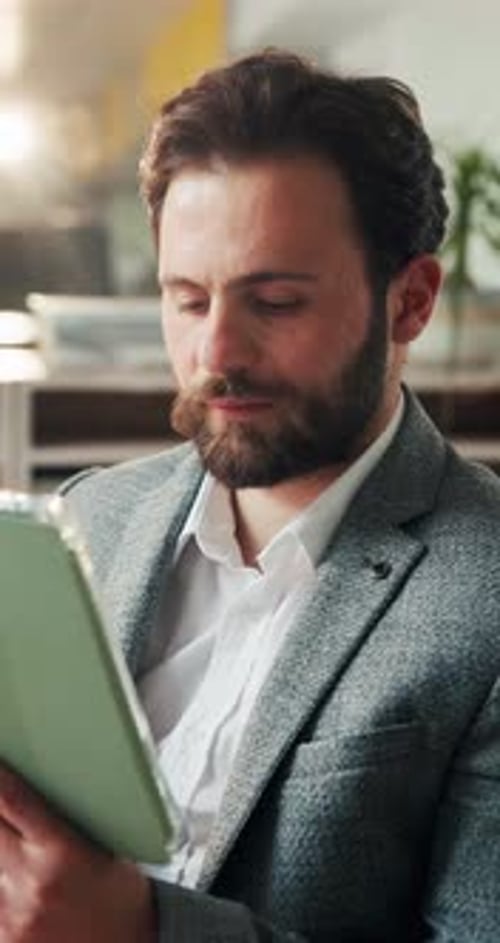 Creative, man and reading with tablet in office for research, proofreading and story submission