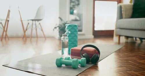 Yoga Mat with Fitness Equipment on a Wood Floor