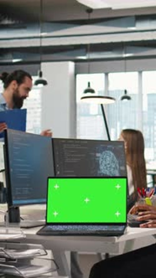 Vertical Video Technician Using Mockup Laptop Next to Office Coworkers Developing Applications