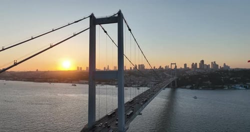 Istanbul Bosphorus Bridge and City Skyline in Background with Turkish Flag at Beautiful Sunset