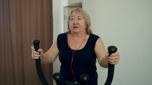 Woman Exercising on Elliptical Machine at Home