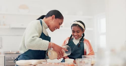 Woman and Child Baking Together in Kitchen