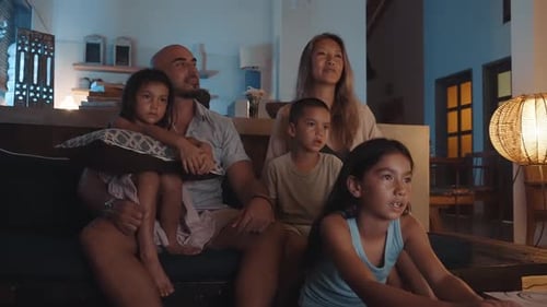 Family Watching Television Together at Night