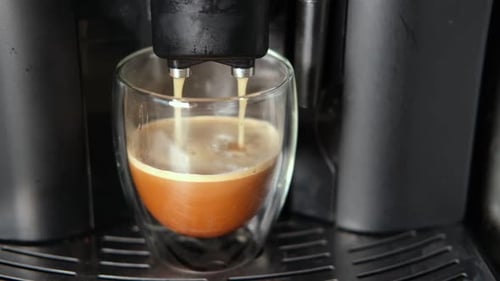 Espresso Machine Pours Coffee into Clear Glass