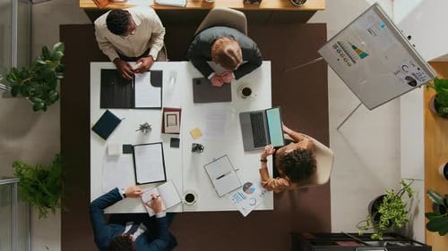 Team Collaborating at Conference Table in Modern Office