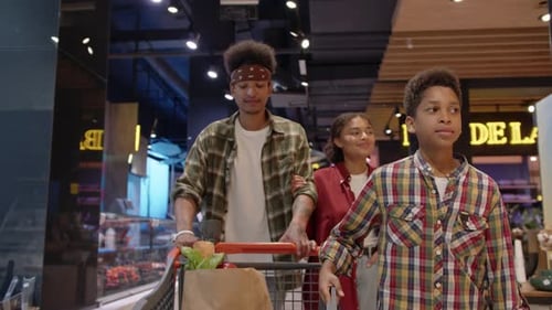 African American Family Passing By Hall of Supermarket