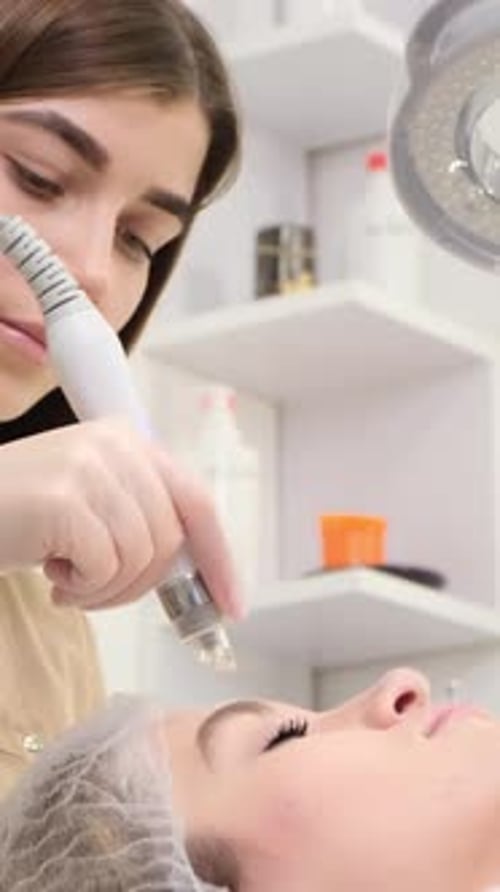 Professional Beautician Woman Doing Hydrafacial Procedure in Cosmetology Clinic Cleaning Procedure